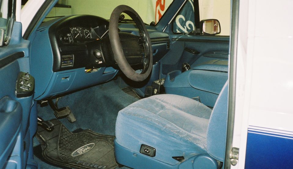 Interior shot of a 1996 Ford Bronco, showing the driver's seat, dashboard, and steering wheel