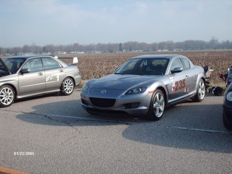 1995 Ford Probe - Two cars are parked on asphalt with a field in the background. The date 01/23/2005 is visible.