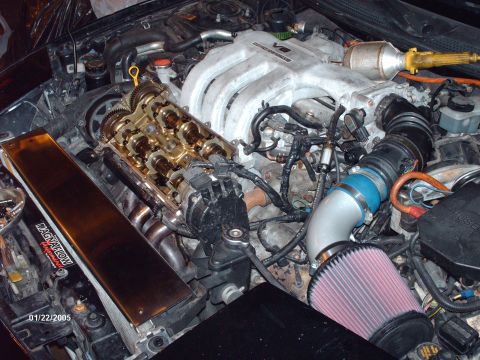1995 Ford Probe - Close-up view of a car's engine bay, showing internal engine components and aftermarket modifications.