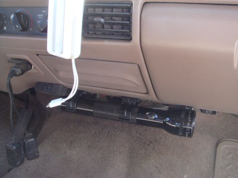 1996 Ford Bronco - Flashlight mounted under the dashboard, with charging cables plugged into the power outlet.
