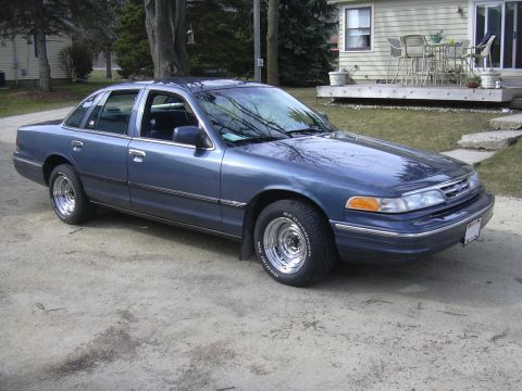 1996 Ford Crown Victoria - This blue 1996 Ford Crown Victoria sedan is shown from a three-quarter front view, chrome wheels and a clean exterior.