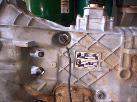 1995 Ford Bronco - Ford transmission housing with a data plate showing part information.