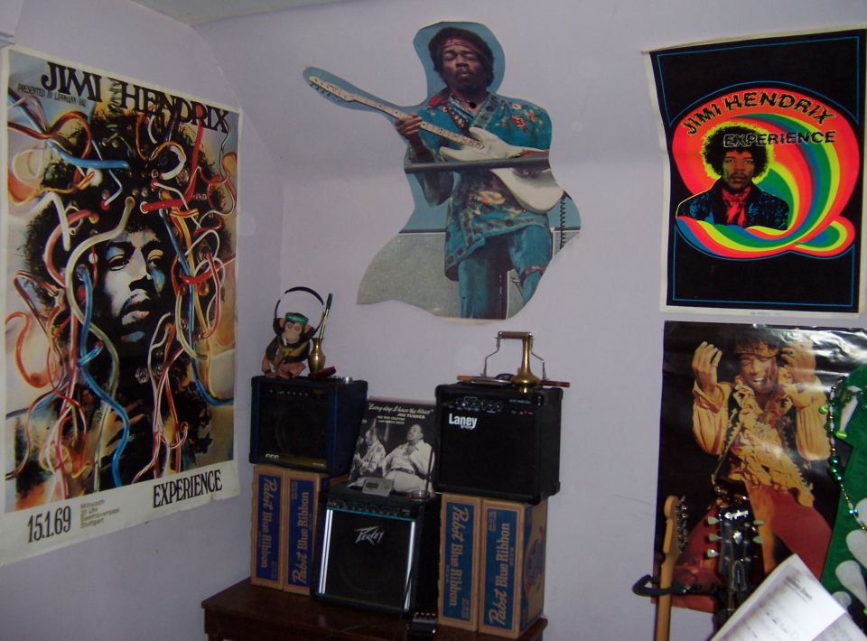 Wall of Jimi Hendrix posters over small guitar amps on PBR boxes