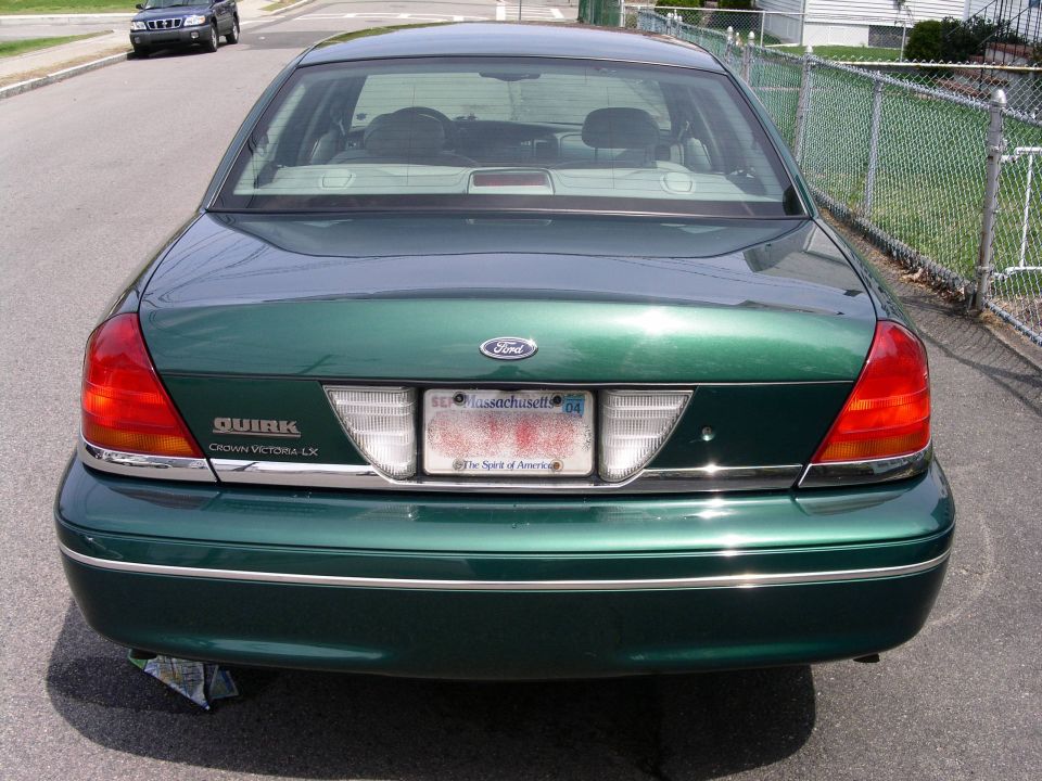 Rear view of a green 2001 Ford Crown Victoria LX with Massachusetts plates