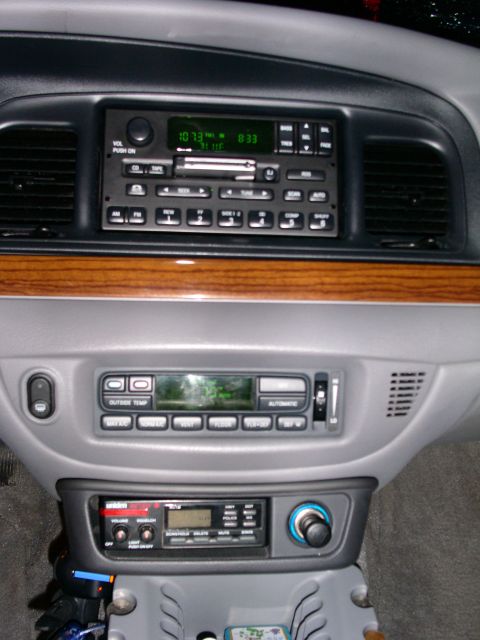 2001 Ford Crown Victoria - The dashboard features a factory radio, an aftermarket radio, and a CB radio unit.
