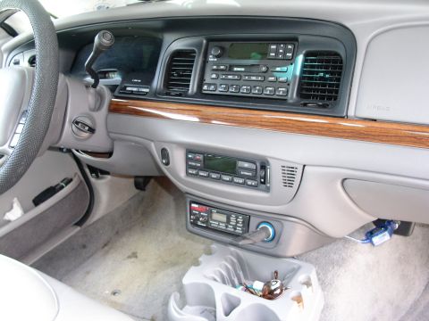 2001 Ford Crown Victoria - The interior of a 2001 Ford Crown Victoria is visible, the dashboard, steering wheel, and center console.