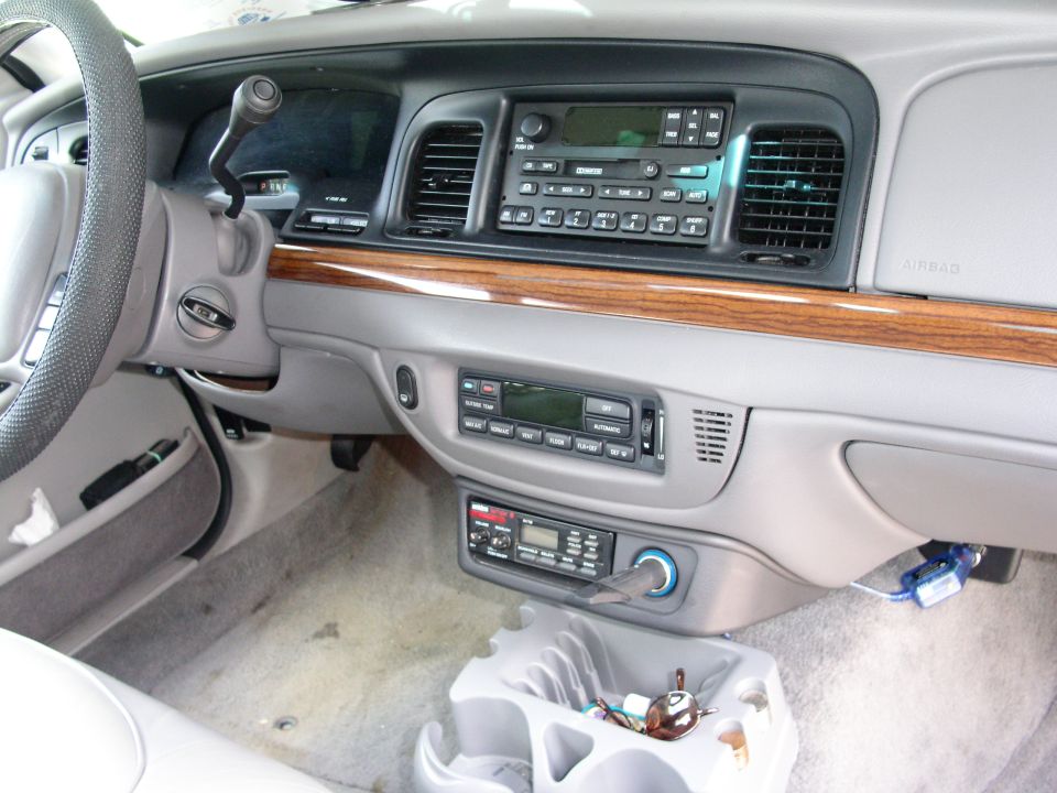 2001 Ford Crown Victoria interior showing dashboard, steering wheel, and center console with aftermarket radio