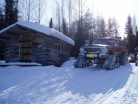 2000 Ford E350 - This modified Jeep Grand Wagoneer is equipped with snow tracks for traversing snowy terrain.