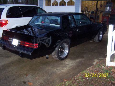 1979 Ford F-150 - Black coupe with aftermarket wheels parked in a driveway next to a minivan.