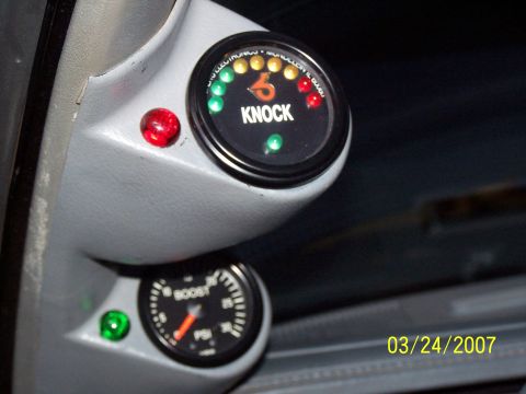 1979 Ford F-150 - A close-up shot of aftermarket gauges, including a boost gauge and a knock gauge, installed in a vehicle's interior.