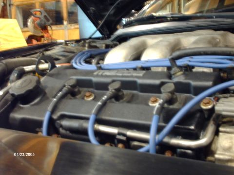 1995 Ford Probe - Close-up view of a car's engine bay, showing spark plug wires and intake manifold.