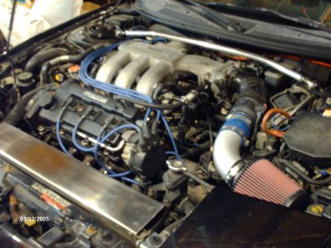 1995 Ford Probe - Engine bay detail with aftermarket intake and visible 'Mazda' branding on the engine block.