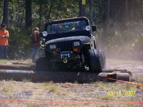 1989 Ford Bronco - A Jeep Wrangler navigates an obstacle course with large logs on March 18, 2007.