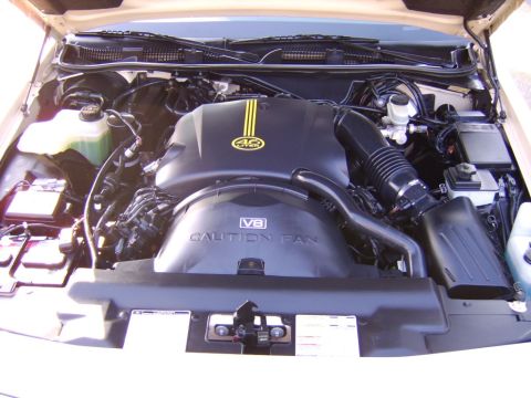 1996 Mercury Grand Marquis - The engine bay of a 1996 Mercury Grand Marquis is shown, highlighting the V8 engine and its components.