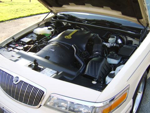 1996 Mercury Grand Marquis - The engine compartment of a 1996 Mercury Grand Marquis is open, revealing the V8 engine and its components.