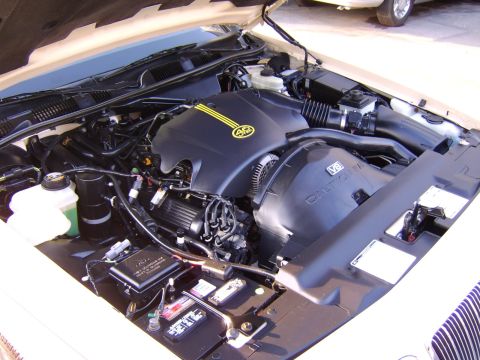 1996 Mercury Grand Marquis - Close-up view of the engine bay, the V8 engine cover with a distinctive yellow 4.6 emblem.