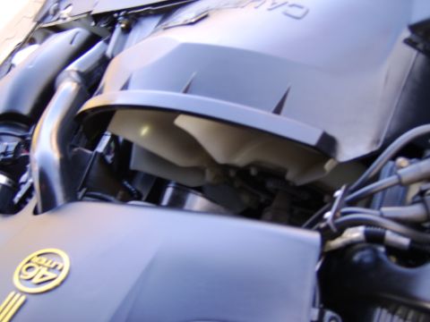 1996 Mercury Grand Marquis - Close-up of the engine bay, a 4.6L badge and cooling fan, consistent with a 1996 Mercury Grand Marquis.