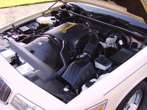 1996 Mercury Grand Marquis - The engine compartment of a 1996 Mercury Grand Marquis is shown with the hood open, revealing the V8 engine.