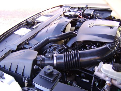 1996 Mercury Grand Marquis - Close-up view of a car's engine bay, showing various components and hoses.