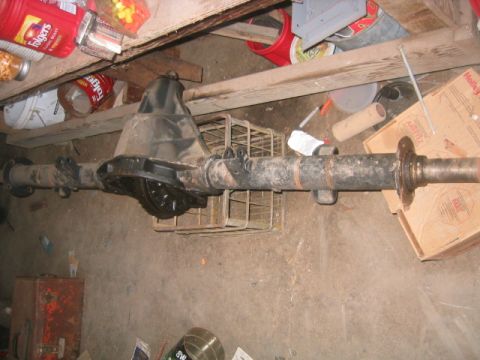 1973 Ford F-100 - A rear axle assembly is shown, likely for a truck or heavy-duty vehicle, resting on a workshop floor.