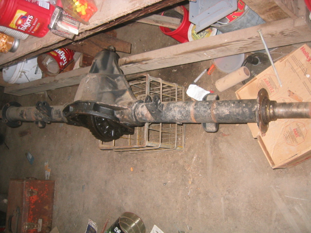 Rear axle assembly with differential housing and brake drum mounting flange