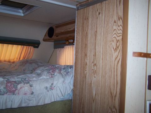 1989 Ford F-250 - Interior view of a camper van, showing a bed and cabinetry.