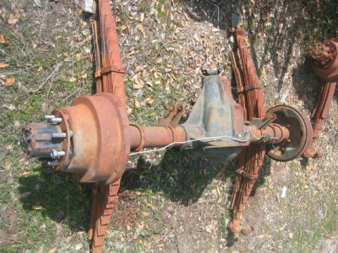 1973 Ford F-100 - Rear axle assembly with leaf springs, likely from an older truck, showing significant rust.