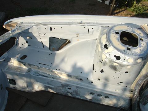 1992 Ford Taurus - The engine bay of a car is shown, appearing to be in a state of repair or restoration.