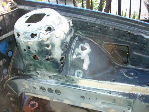 1992 Ford Taurus - Engine bay showing bodywork in progress, with primer and filler applied to the metal surfaces.