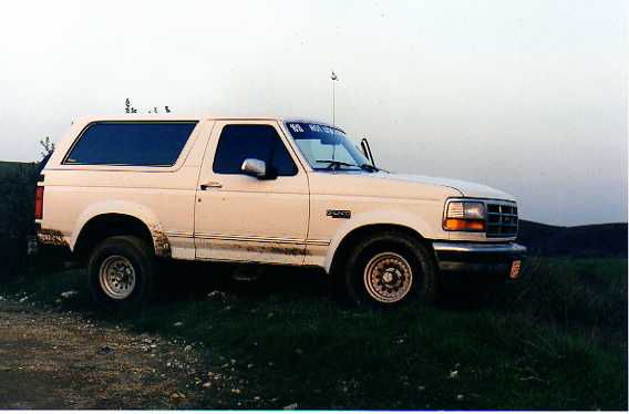 White 1990s full-size Ford Bronco parked outdoors