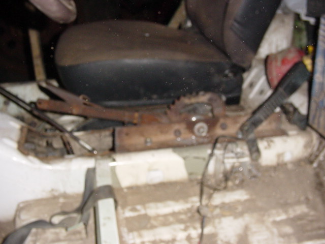 Interior view of vehicle seat mechanism and dirty floor