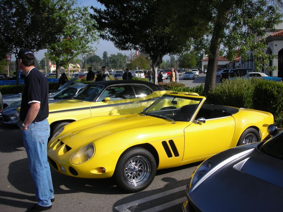 Yellow open-top Ferrari 250 GTO-style classic on wire wheels at a car show