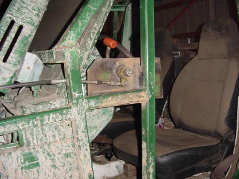 1992 Ford Bronco - Interior of a vehicle showing a green frame and brown seats, with visible mechanical components.