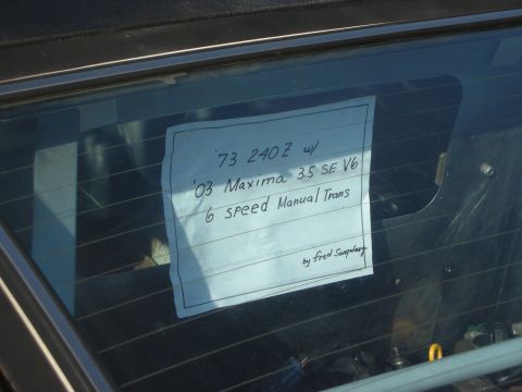 1998 Ford Crown Victoria - Handwritten window sign describing a 1973 Datsun 240Z fitted with a 2003 Maxima 3.5 V6 and six-speed manual.