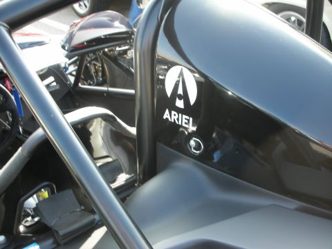 1998 Ford Crown Victoria - Close-up of a black side panel bearing the Ariel triangle logo and 'ARIEL' lettering on a skeletal tube-frame track car.
