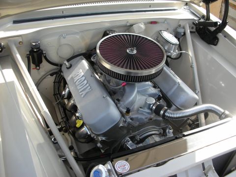 1998 Ford Crown Victoria - polished V8 engine topped with a round red performance air filter sits in a white-painted engine bay with braided lines.