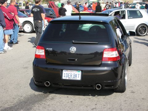 1998 Ford Crown Victoria - black Volkswagen Golf R32 hatchback is shown from the rear with dual exhausts and a California 1DER BKT plate.
