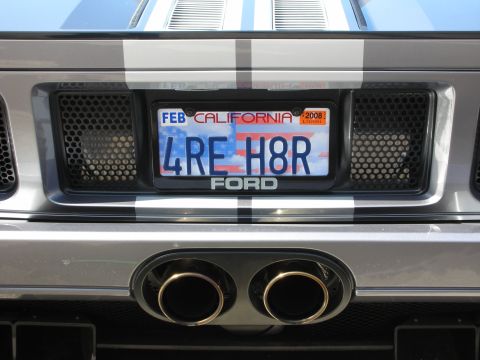 1998 Ford Crown Victoria - Rear detail of a silver Ford GT showing a California plate 4RE H8R, FORD lettering and dual exhaust tips.