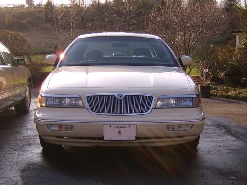 1996 Mercury Grand Marquis - Front view of a cream-colored 1995 Mercury Grand Marquis parked outdoors.