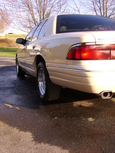 1996 Mercury Grand Marquis - Rear quarter view of a tan 1996 Mercury Grand Marquis sedan.
