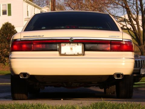 1996 Mercury Grand Marquis - Rear view of a cream-colored sedan with dual exhaust pipes and a Maryland license plate.