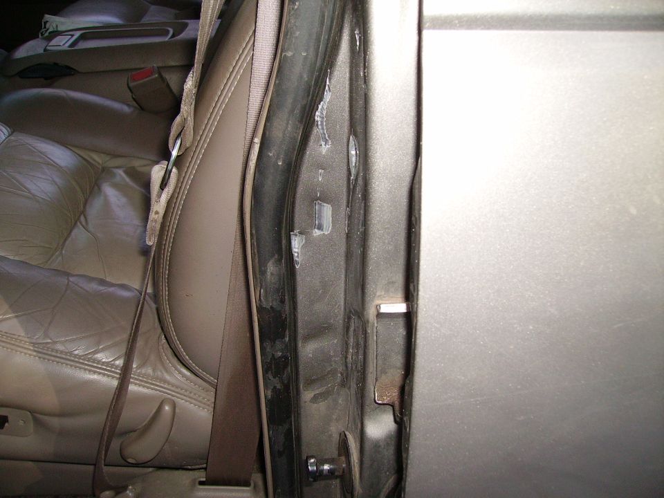 Interior door frame and tan leather seat