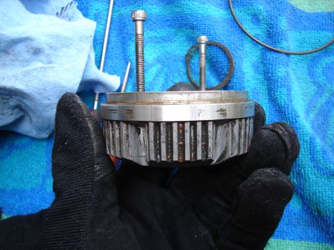 1996 Ford Bronco - A worn manual hub part is held by a gloved hand against a blue towel background.