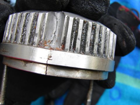 1996 Ford Bronco - Close-up of a damaged metal component, showing cracks and wear.