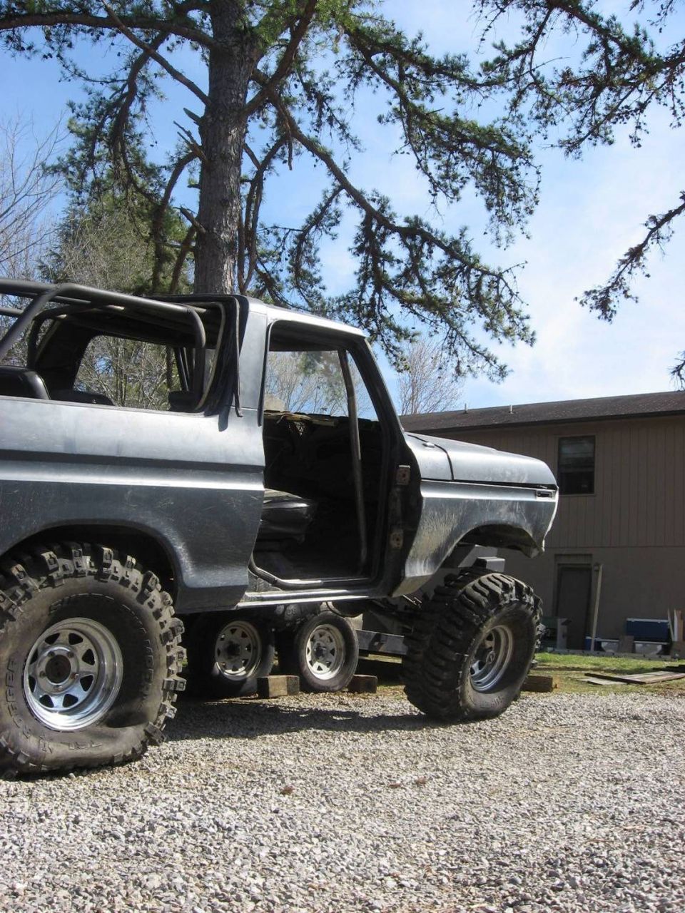 1979 Ford Bronco with roll cage and large tires, doors removed