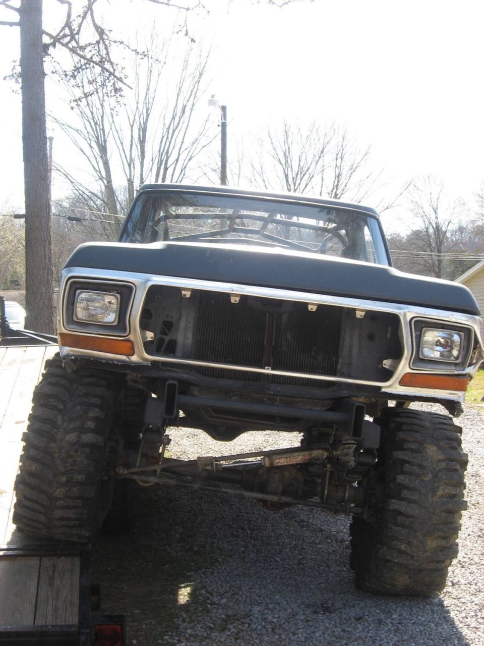 1979 Ford Bronco front end with large tires and no grille