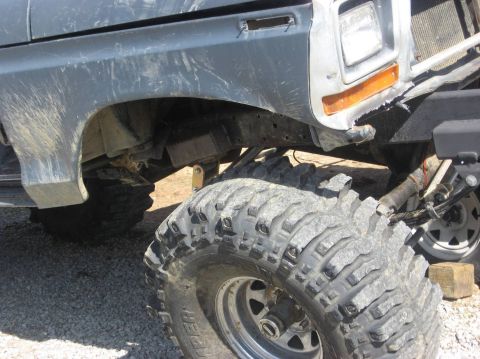 1979 Ford Bronco - Close-up of a lifted Ford Bronco's front fender and large off-road tire.