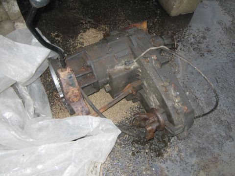 1994 Ford Bronco - Transfer case assembly with shifter linkage and U-joint yoke, appears to be a used part.