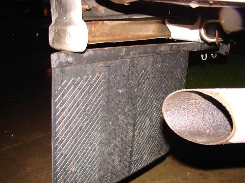 1996 Ford Bronco - Close-up view of a rear mud flap and exhaust pipe, with 'SUPERMOTORS.NET' visible at the bottom.