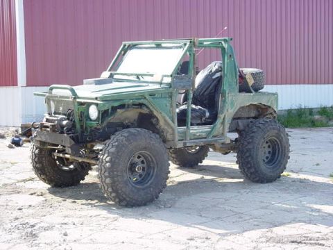 1992 Ford Bronco - This heavily modified off-road vehicle has large tires and an exposed frame.